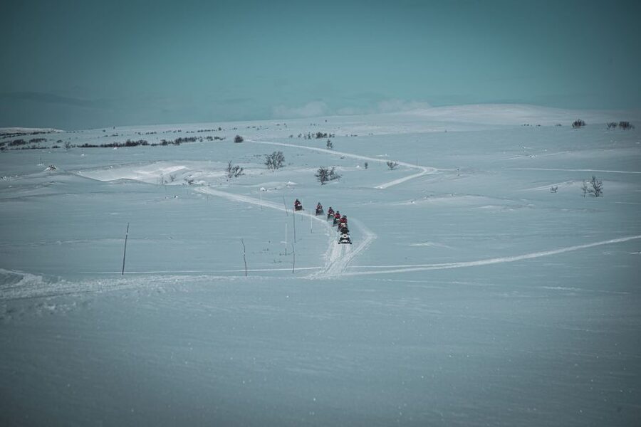 From Alta: Daytime Snowmobile Adventure - Riding in pairs across the old postal road