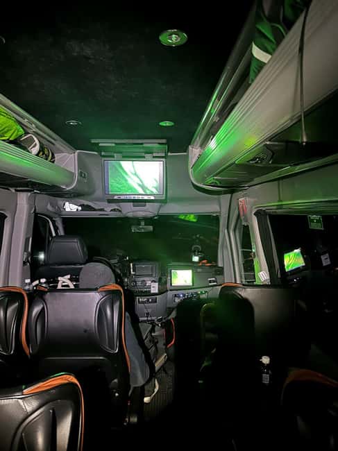 From Tromsø: Aurora Minibus Chase with Portrait and Hot Meal - Warm suits, boots, ice spikes, and a heated toilet